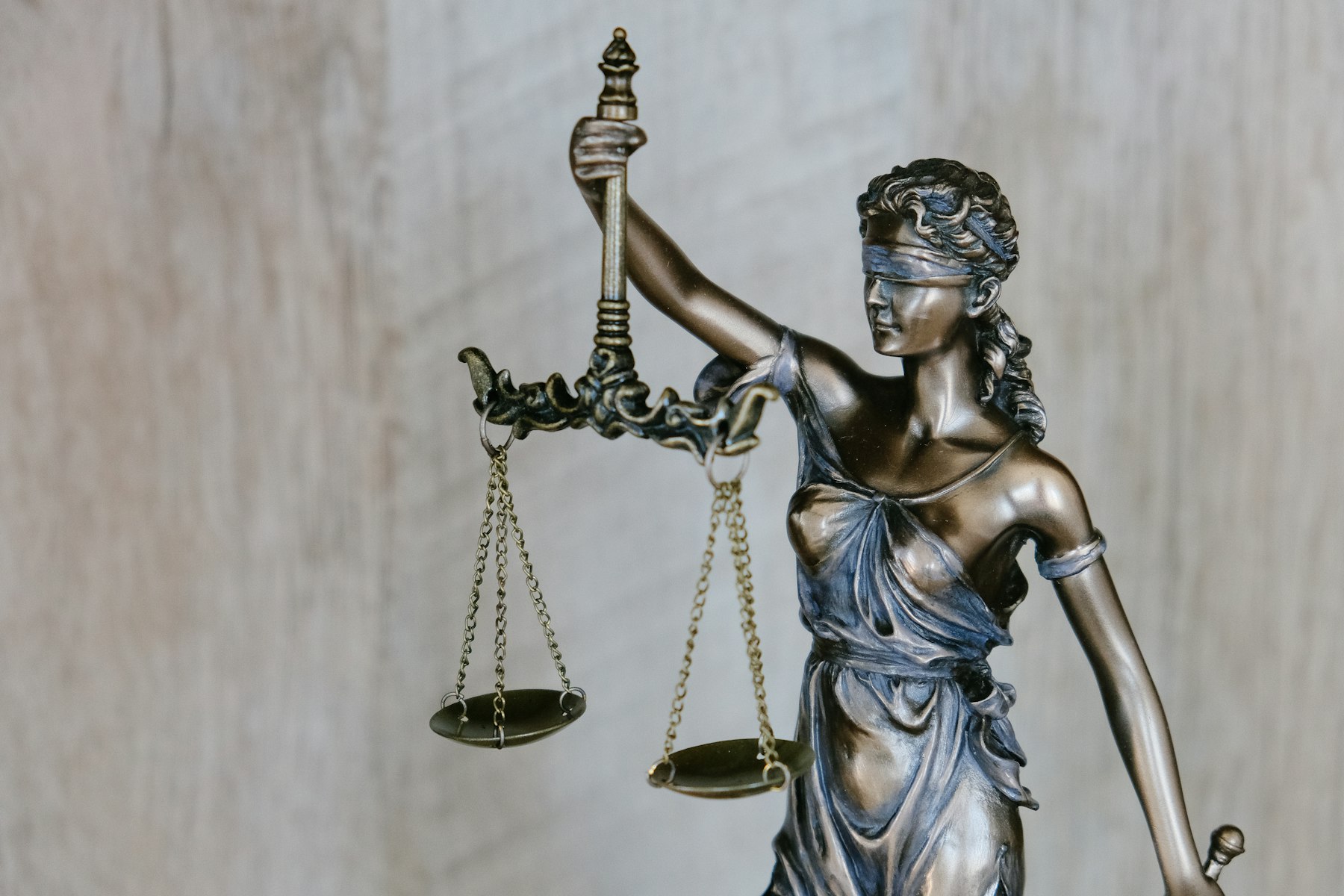 Bronze statue of Lady Justice, blindfolded and holding a set of scales
